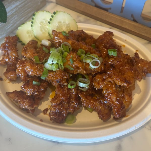 Gen Thai Street Food's crispy chicken with sweet chili sauce, green onions, and cucumber slices.
