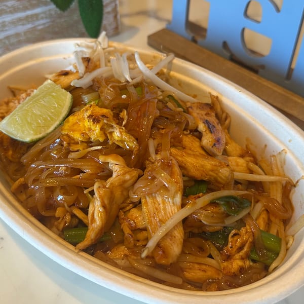 Gen Thai Street Food's chicken pad see ew with noodles, bean sprouts, and a lime wedge.
