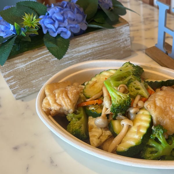 Gen Thai Street Food's stir-fried vegetables and tofu in a white bowl on a marble table.